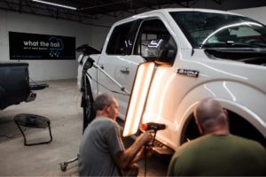 Experienced PDR technician working precisely on hail damage using specialized tools, Downers Grove, Hinsdale, Clarendon Hills, IL